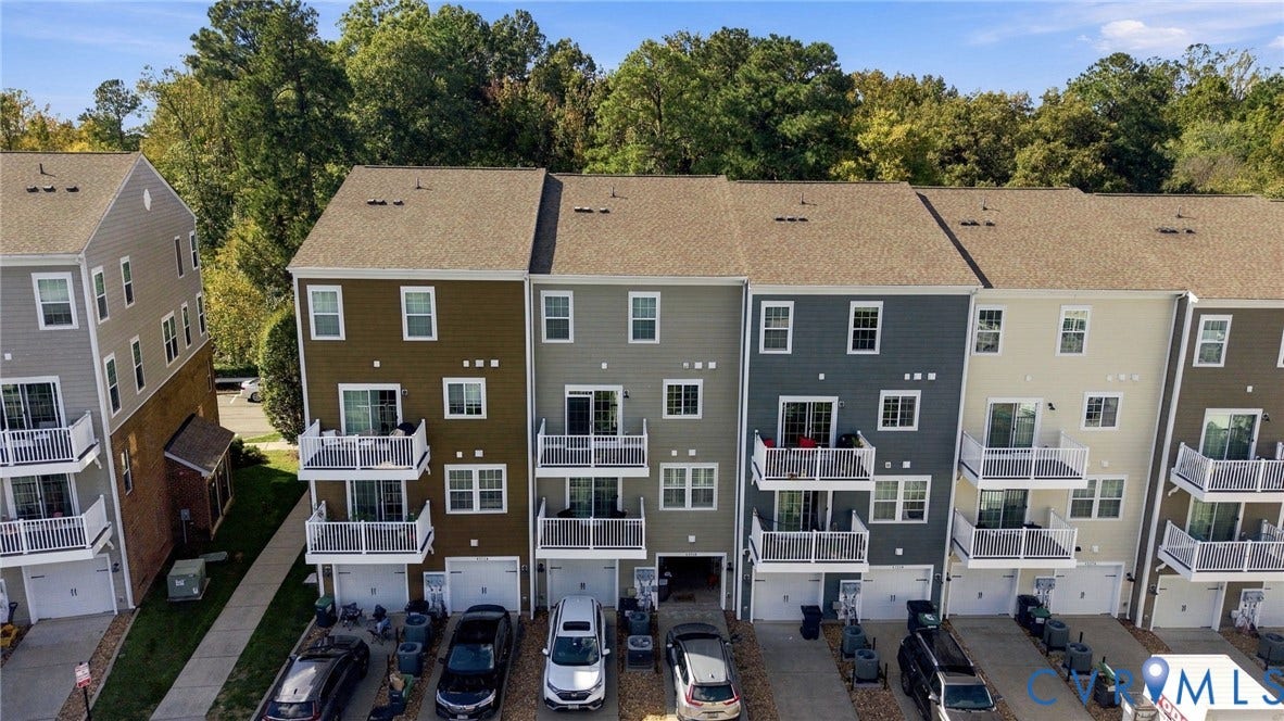 4223 Saunders Tavern Trail, #A, Henrico, VA 23233 Multi-level townhouse exteriors featuring varied siding colors, individual private balconies, attached garages, and asphalt shingle roofing