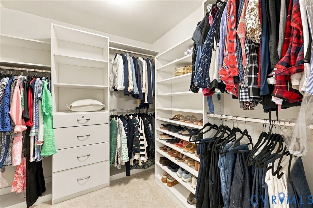 4223 Saunders Tavern Trail, #A, Henrico, VA 23233 Walk-in closet featuring white built-in shelving, multiple hanging rods, and integrated storage drawers