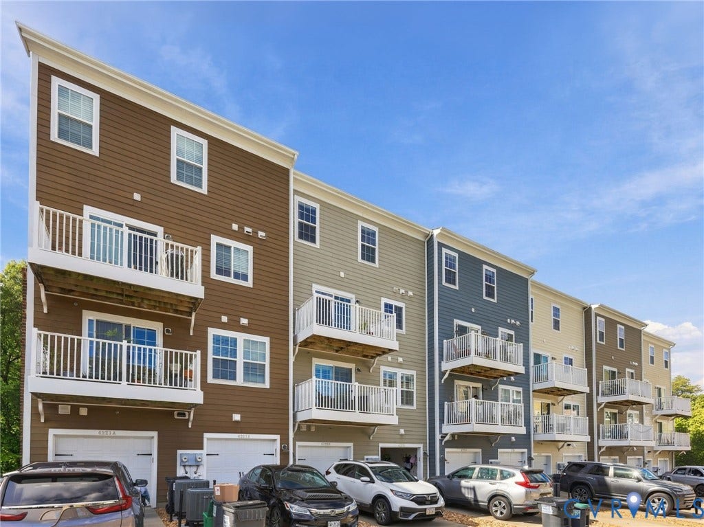 4223 Saunders Tavern Trail, #A, Henrico, VA 23233 Multi-story townhome exterior featuring horizontal lap siding, stacked private balconies with white railings, and attached ground-level garages