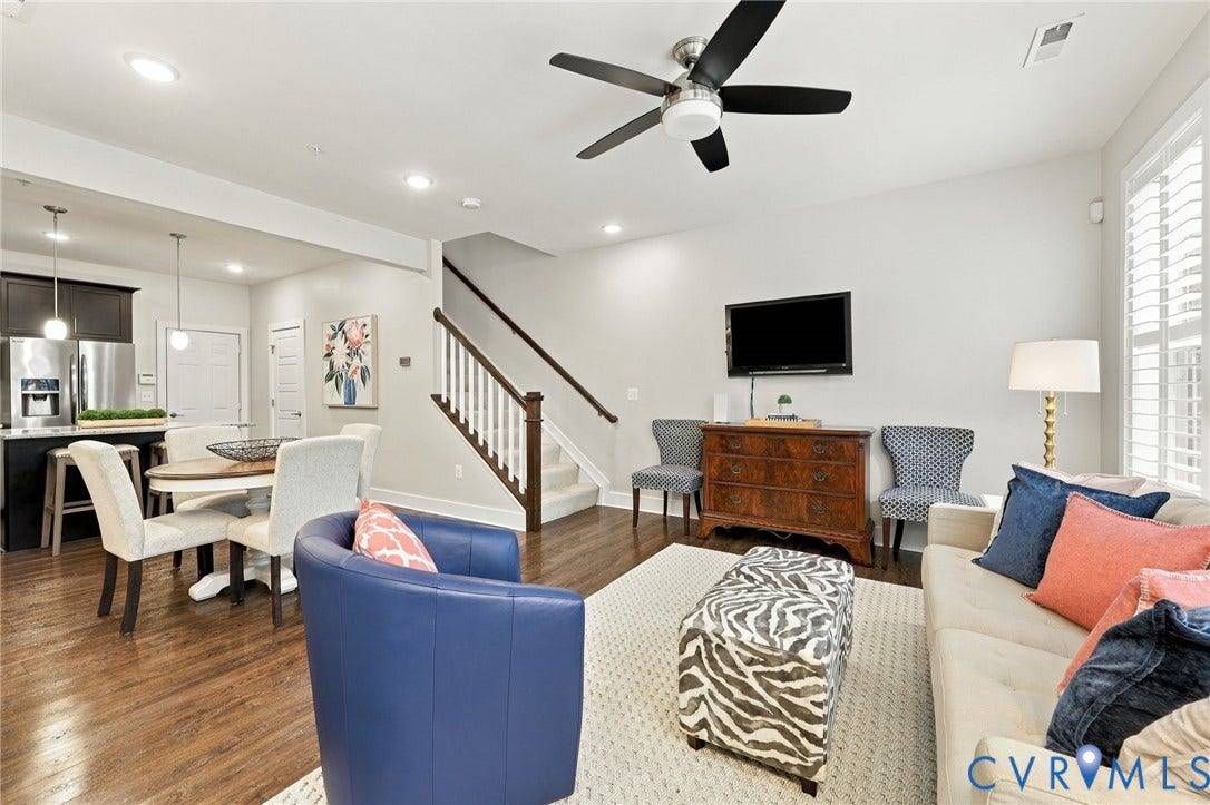 4223 Saunders Tavern Trail, #A, Henrico, VA 23233 Open-concept living space featuring wood-finish flooring, recessed lighting, a modern ceiling fan, and a staircase with a wooden handrail and white balusters