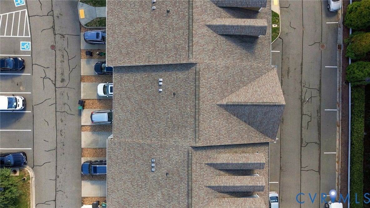 4223 Saunders Tavern Trail, #A, Henrico, VA 23233 Aerial perspective of a multi-unit structure featuring a shingled roof with prominent gables and dormers, complemented by paved parking areas