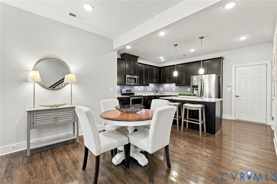 4223 Saunders Tavern Trail, #A, Henrico, VA 23233 Kitchen featuring dark-stained cabinetry, stainless steel appliances, a kitchen island with stone-surface countertop, and wood-finish flooring