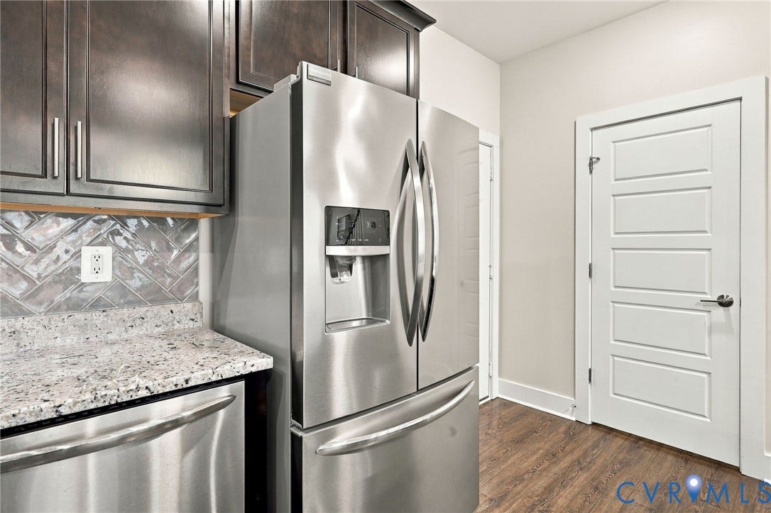 4223 Saunders Tavern Trail, #A, Henrico, VA 23233 Kitchen featuring dark-finish cabinetry, stainless steel French-door refrigerator, granite countertops, herringbone-patterned tile backsplash, and wood-finish flooring