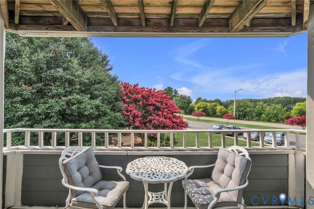Covered balcony featuring wood-plank ceiling, structural white railing, and exterior horizontal siding