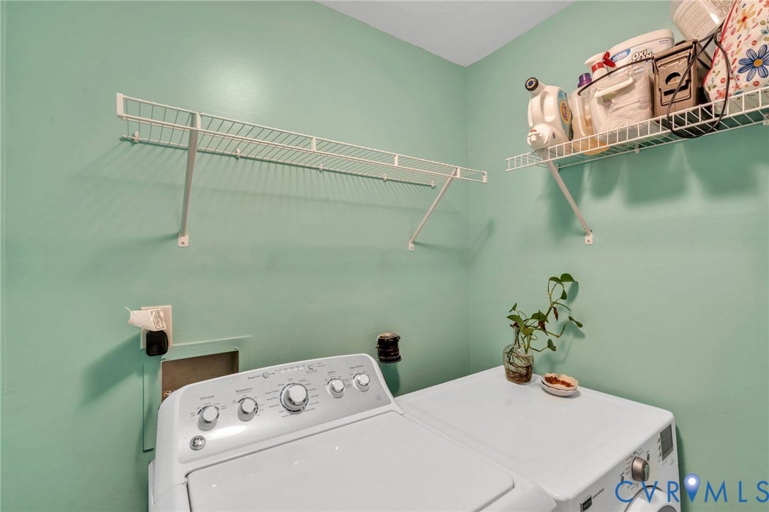 Utility area featuring white wire wall-mounted shelving units