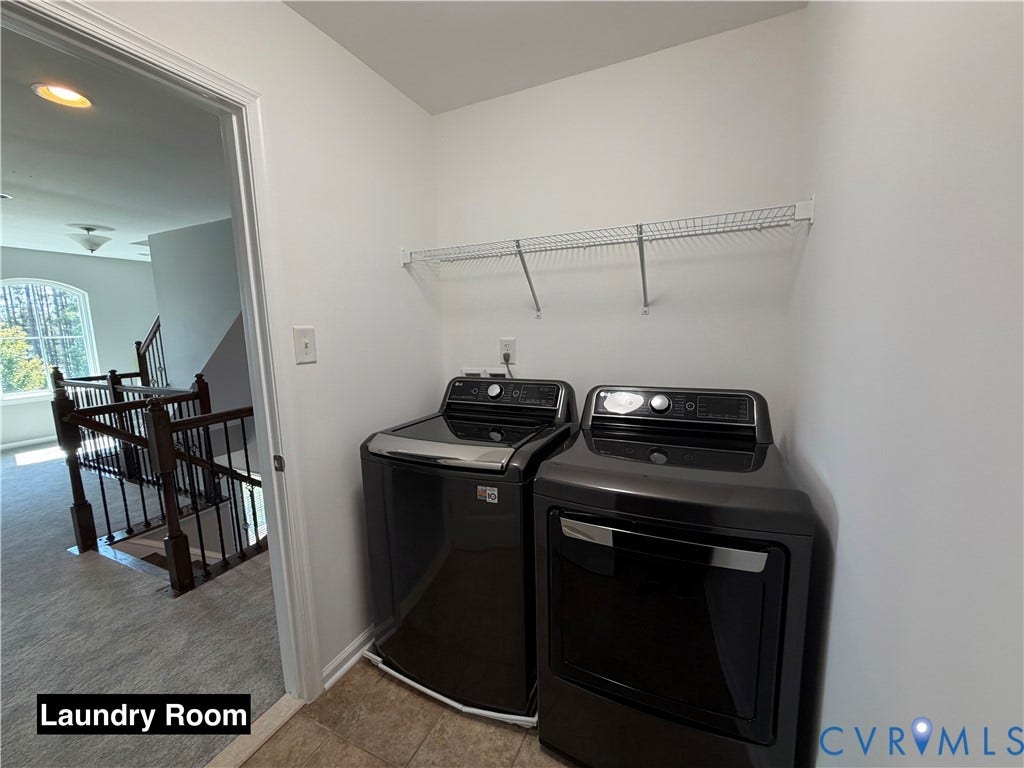 Laundry area featuring tile flooring, neutral wall paint, and overhead wire shelving