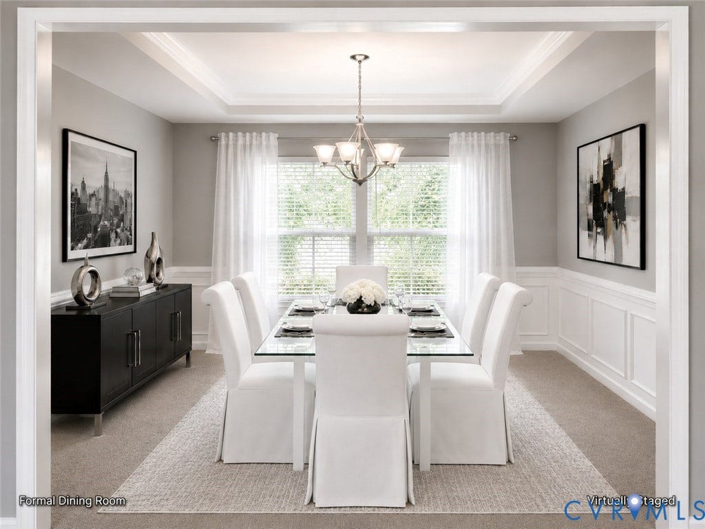 Elegant formal dining room featuring a coffered ceiling with recessed lighting, large multi-pane windows, wainscoting on accent walls, neutral wall finishes, and wide-plank wood-finish flooring throughout