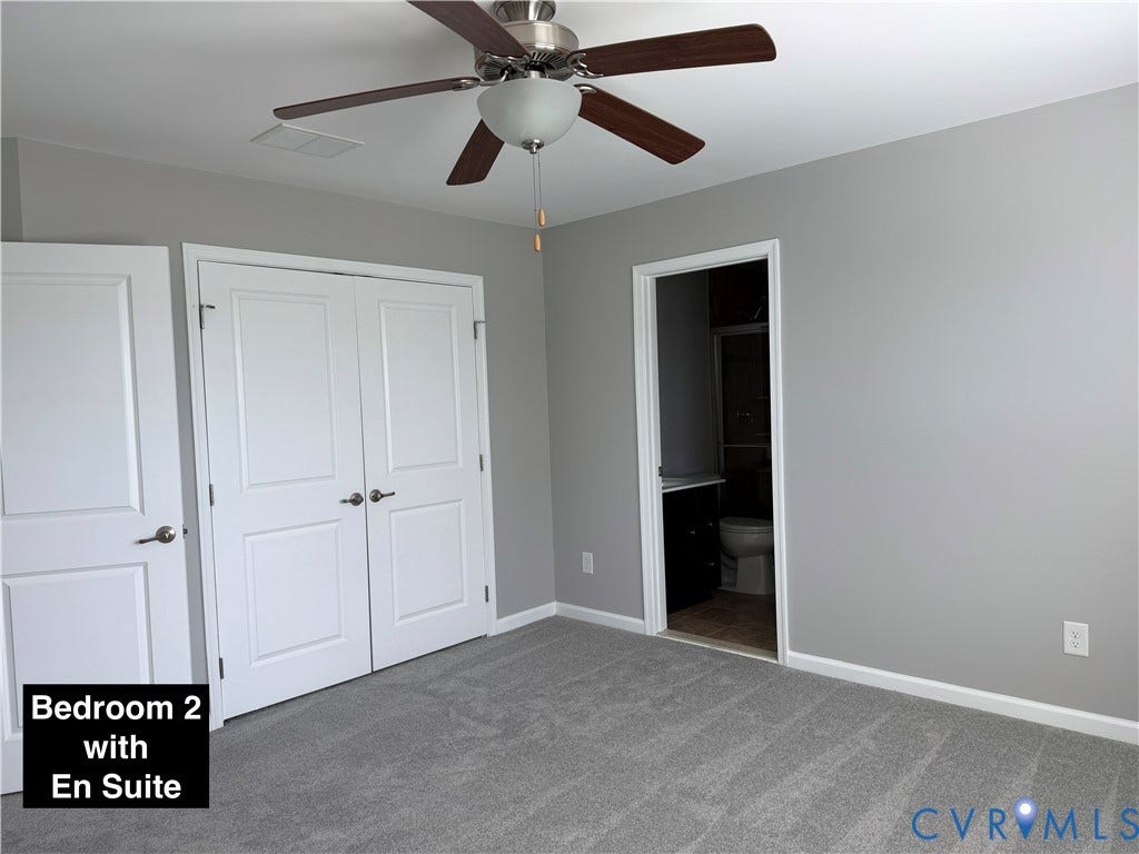Neutral-toned bedroom featuring grey wall-to-wall carpeting, dual-door closet with satin nickel hardware, and a ceiling-mounted fan with integrated lighting