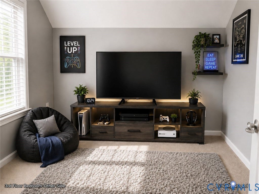 Spacious third-floor bedroom with a distinctive sloped ceiling, multiple windows providing abundant natural light, and carpeted flooring. The room offers a comfortable, versatile layout with a spacious upper-level feel.