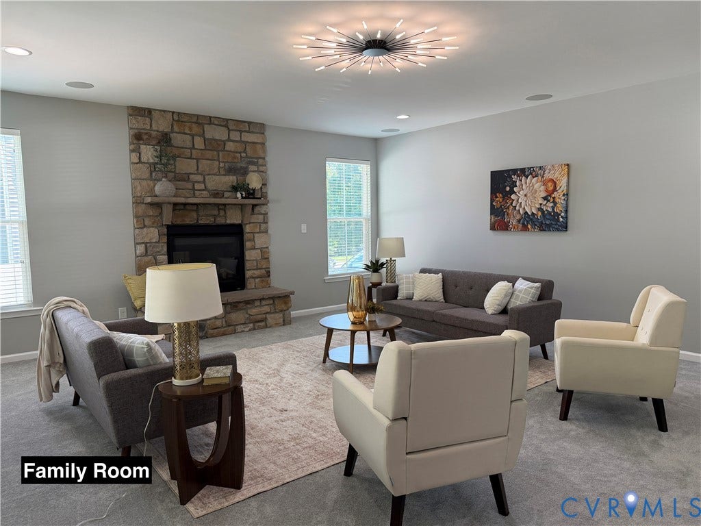 Stone-surround fireplace featuring a prominent mantel and hearth, starburst-style ceiling light fixture, recessed lighting, and multi-pane windows