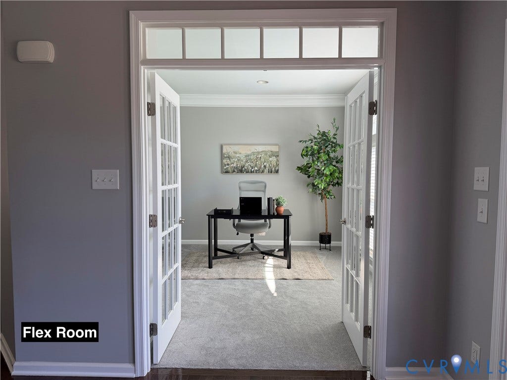 Room featuring double French doors with transom window, crown molding, and wall-to-wall carpeting