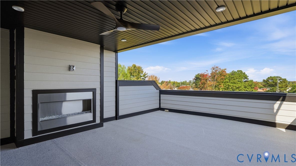 11612 Switch Drive, Midlothian Depot, Midlothian, VA 23113 Covered balcony featuring horizontal lap siding, a built-in linear fireplace, a matte black ceiling fan, and recessed lighting