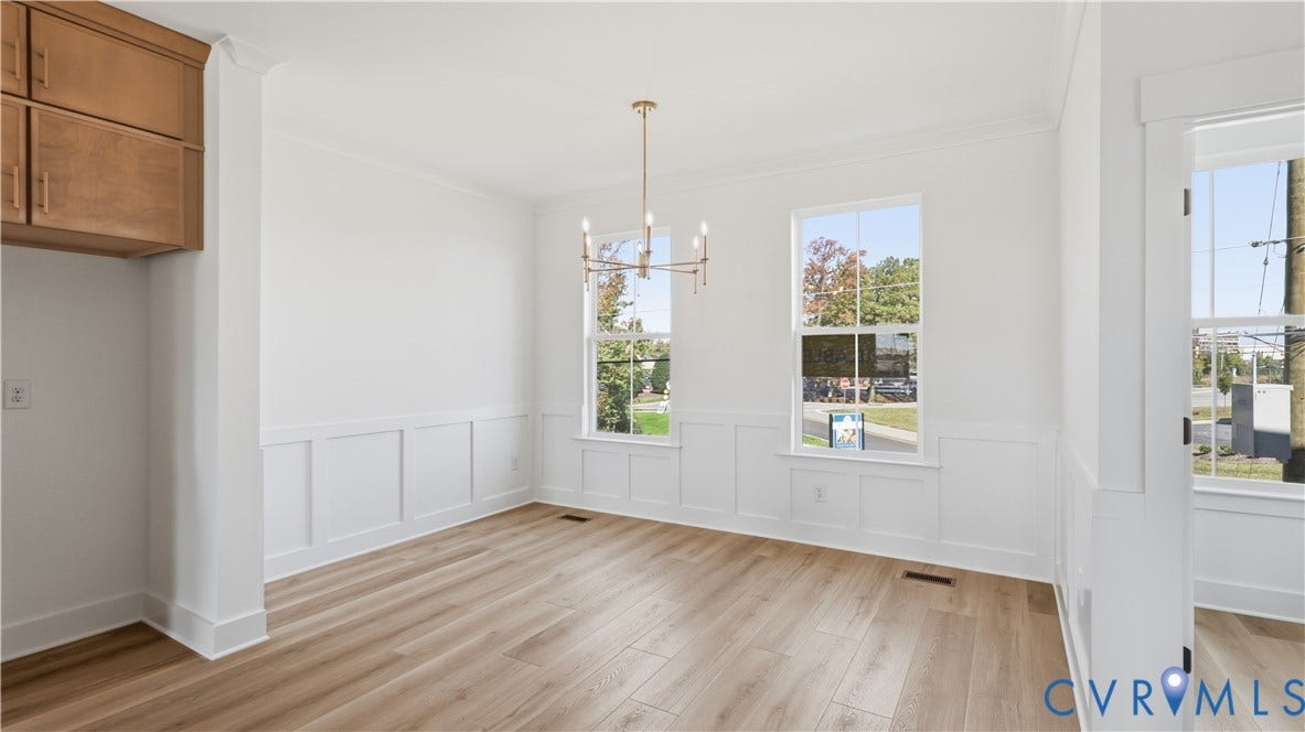 11612 Switch Drive, Midlothian Depot, Midlothian, VA 23113 Bright interior featuring wood-finish flooring, white wall wainscoting, built-in cabinetry, dual-pane windows, and a metallic chandelier