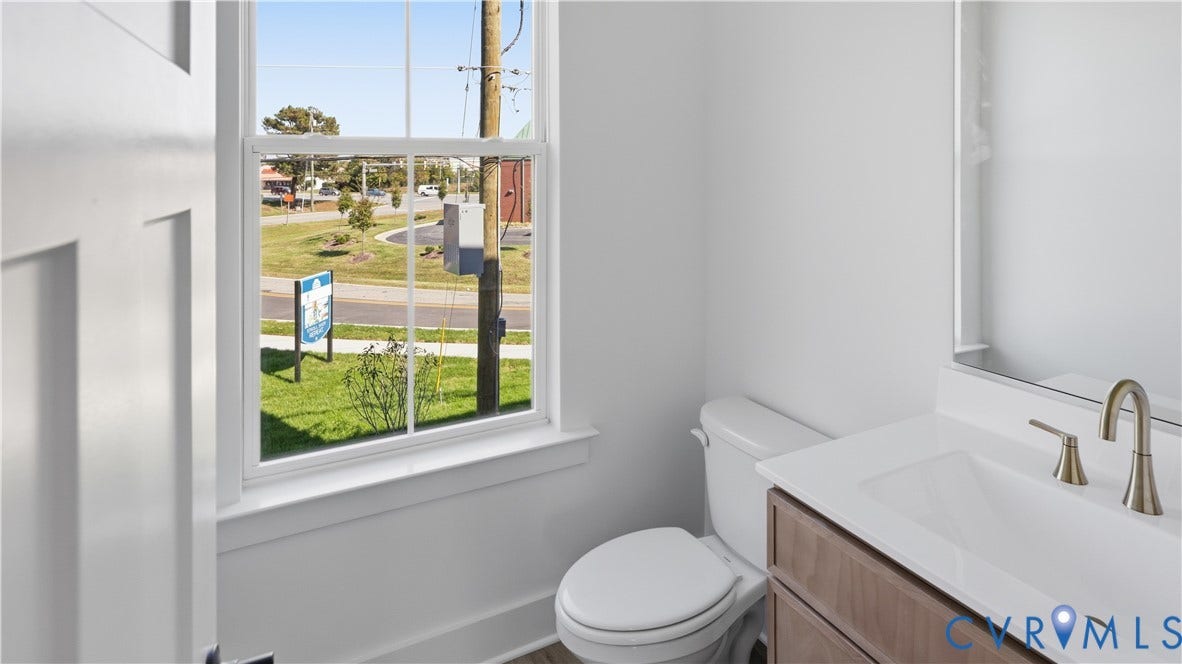 11612 Switch Drive, Midlothian Depot, Midlothian, VA 23113 Single-hung window, white-finish vanity with countertop sink, metallic faucet, and wall-mounted mirror