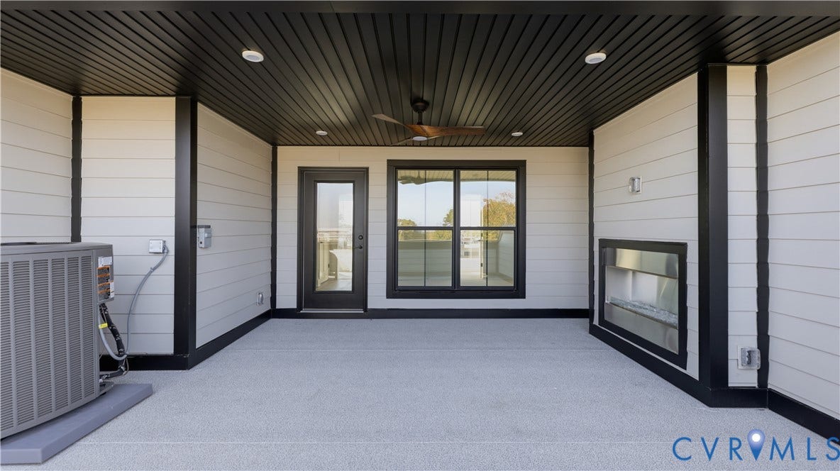 11612 Switch Drive, Midlothian Depot, Midlothian, VA 23113 Covered outdoor patio featuring a black tongue-and-groove ceiling, recessed lighting, integrated ceiling fan, horizontal siding, and a linear built-in fireplace