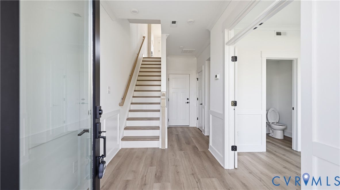 11612 Switch Drive, Midlothian Depot, Midlothian, VA 23113 Entryway featuring wood-finish flooring, wainscoting, a staircase with a wooden handrail, and recessed lighting