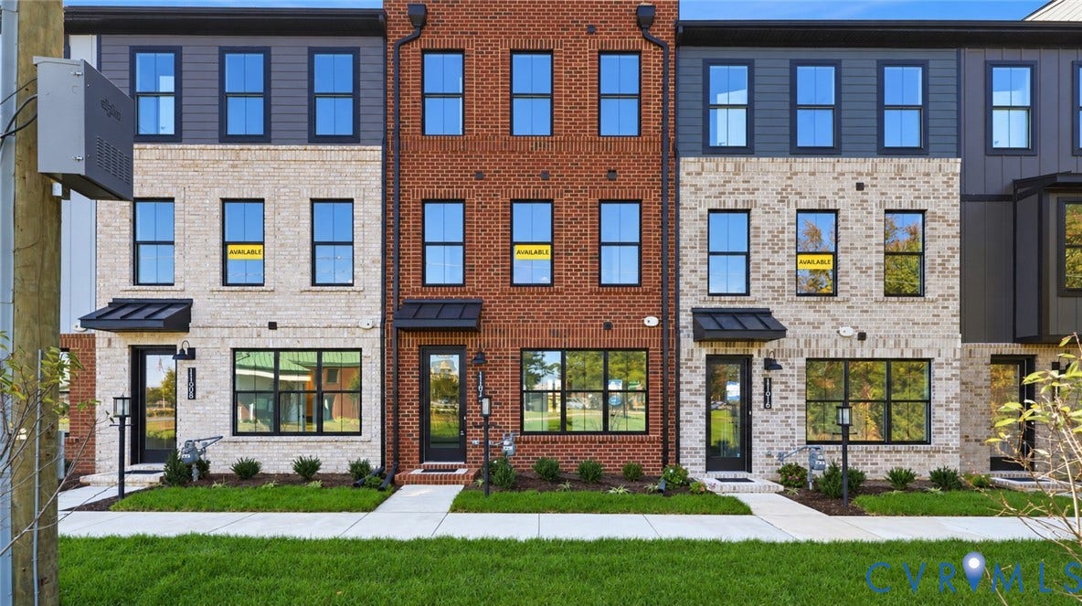 11612 Switch Drive, Midlothian Depot, Midlothian, VA 23113 Modern three-story townhouse exterior featuring mixed-media brick and metal-panel siding, dark-framed multi-pane windows, and black metal door awnings