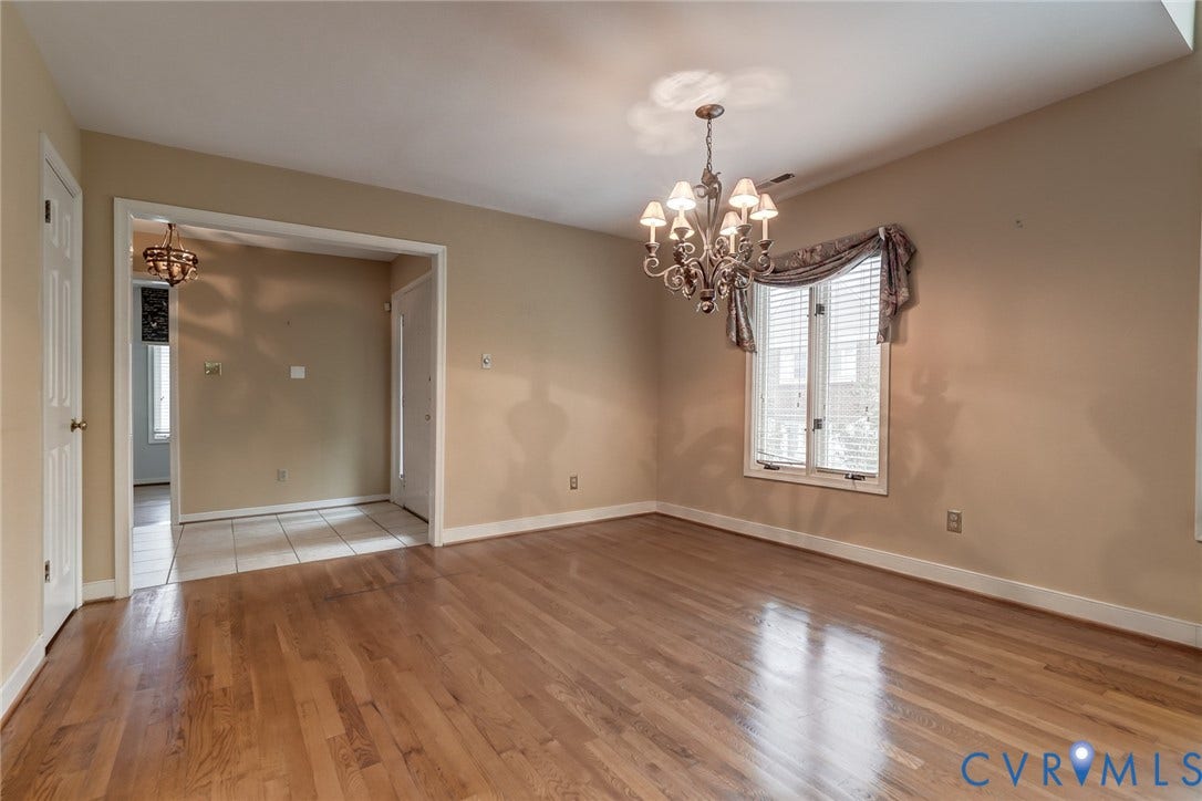 1109 Lakeland Circle, Henrico, VA 23229 Hardwood flooring, multi-light decorative chandelier, multi-pane window with wood trim, and crown molding