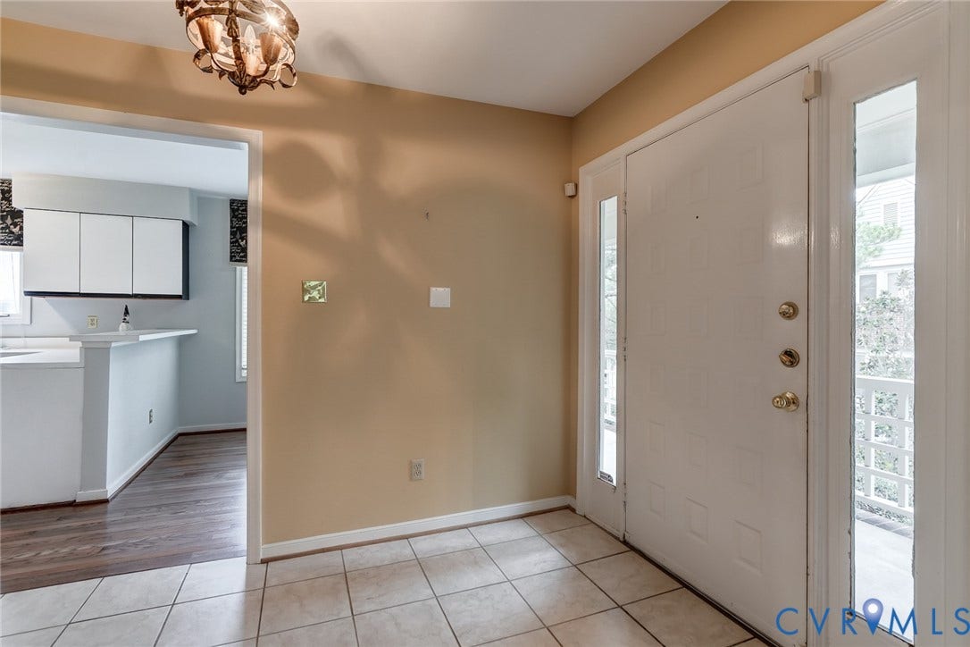 1109 Lakeland Circle, Henrico, VA 23229 Entryway featuring tile flooring, a paneled door with side glass panels, and a multi-arm decorative light fixture