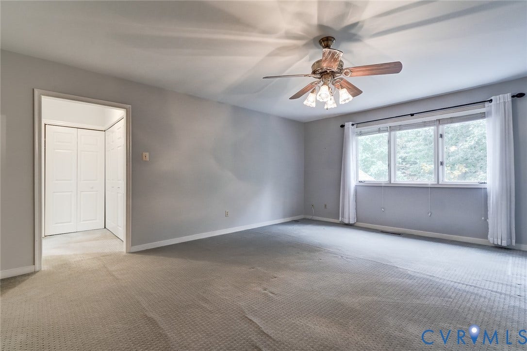 1109 Lakeland Circle, Henrico, VA 23229 Neutral interior space featuring wall-to-wall carpeting, a multi-pane window with a curtain rod, a ceiling fan with integrated lighting, and a closet with bifold doors