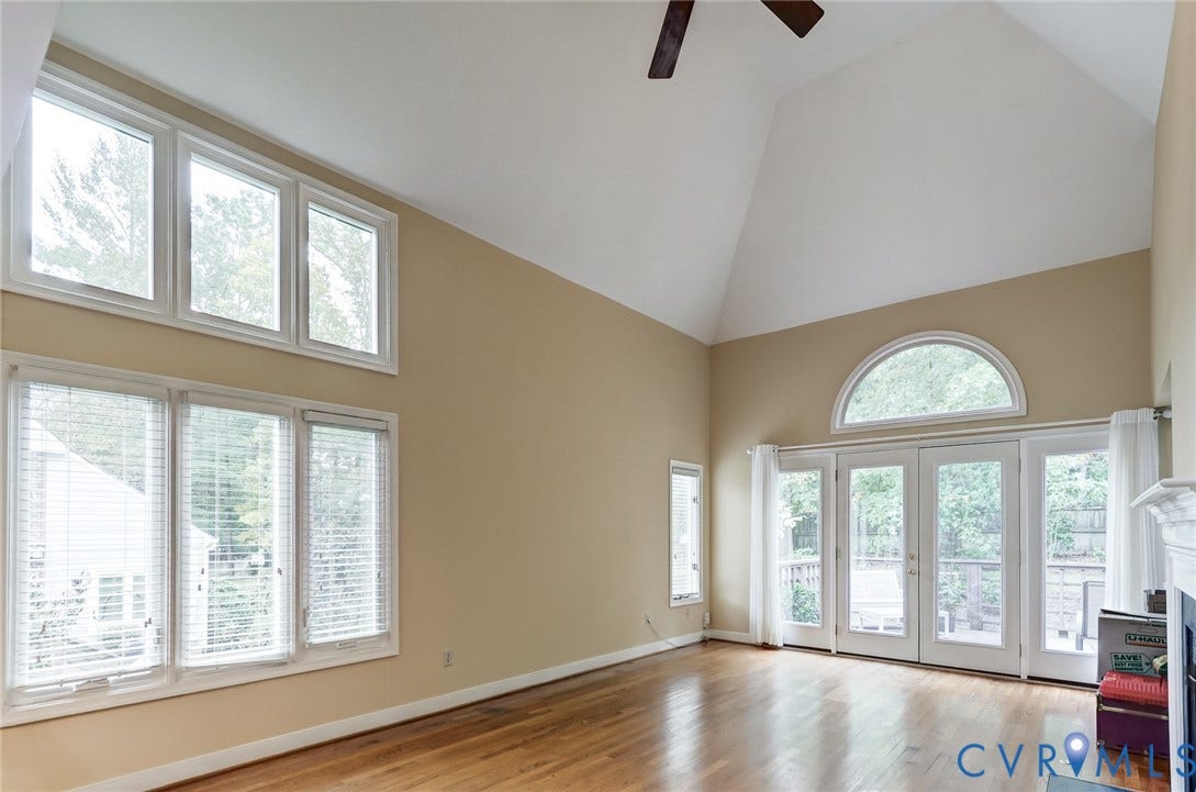 1109 Lakeland Circle, Henrico, VA 23229 Vaulted ceilings featuring a built-in ceiling fan, oversized multi-pane windows, arched transom window, wood-finish flooring, and double glass-pane doors