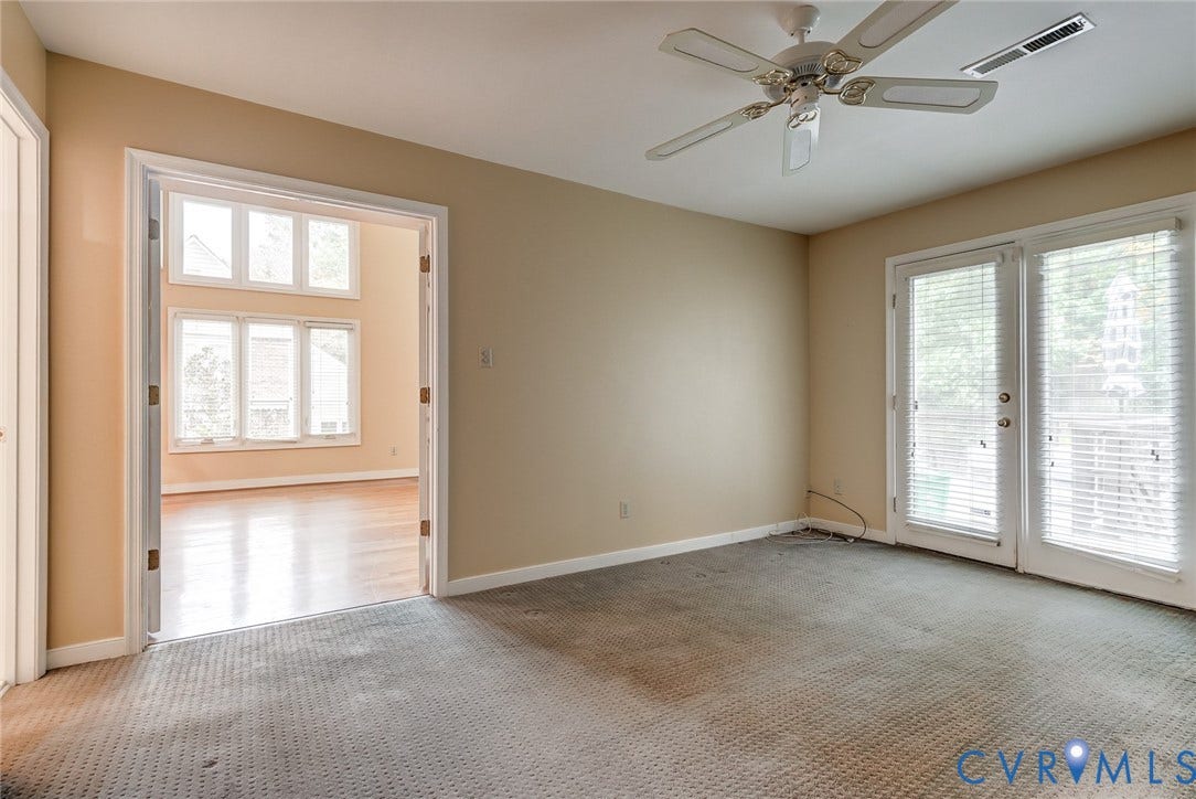 1109 Lakeland Circle, Henrico, VA 23229 Room featuring white-framed double doors, glass-paneled exterior doors, a ceiling fan, and window-lined walls