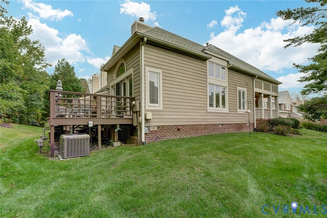 1109 Lakeland Circle, Henrico, VA 23229 Exterior featuring horizontal siding, a brick foundation, arched window detailing, and a raised wooden deck
