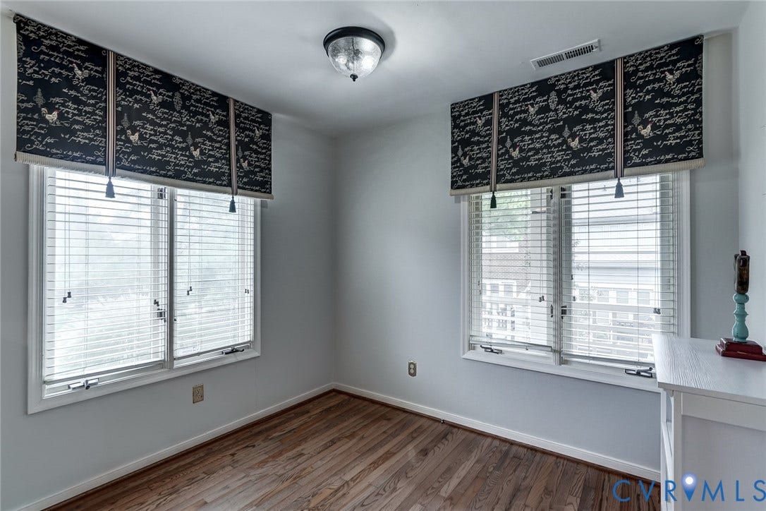 1109 Lakeland Circle, Henrico, VA 23229 Room featuring wood-finish flooring, two windows with horizontal blinds, and a central ceiling-mounted light fixture