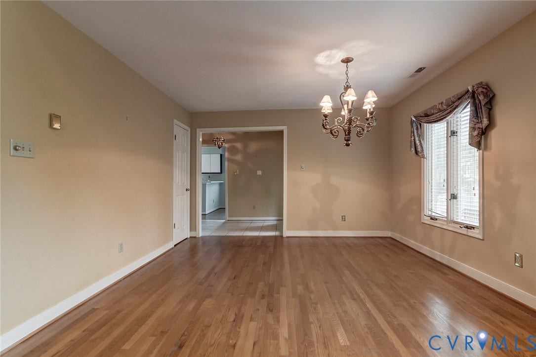 1109 Lakeland Circle, Henrico, VA 23229 Dining area featuring wood-finish flooring, a multi-arm decorative chandelier, and a window with horizontal blinds