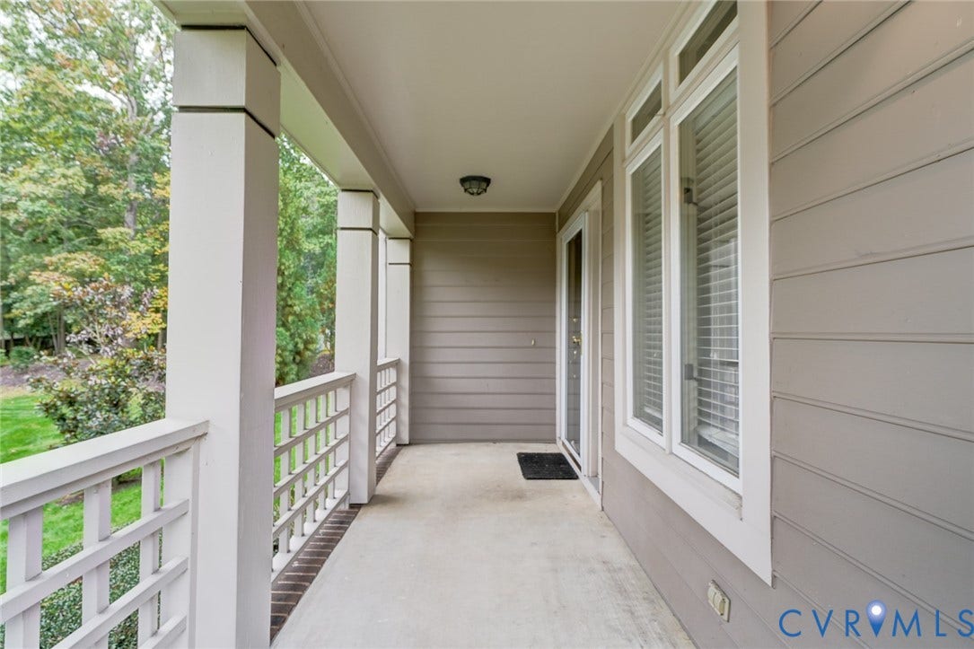 1109 Lakeland Circle, Henrico, VA 23229 Covered porch featuring horizontal lap siding, square structural columns, white latticed railing, and tall windows