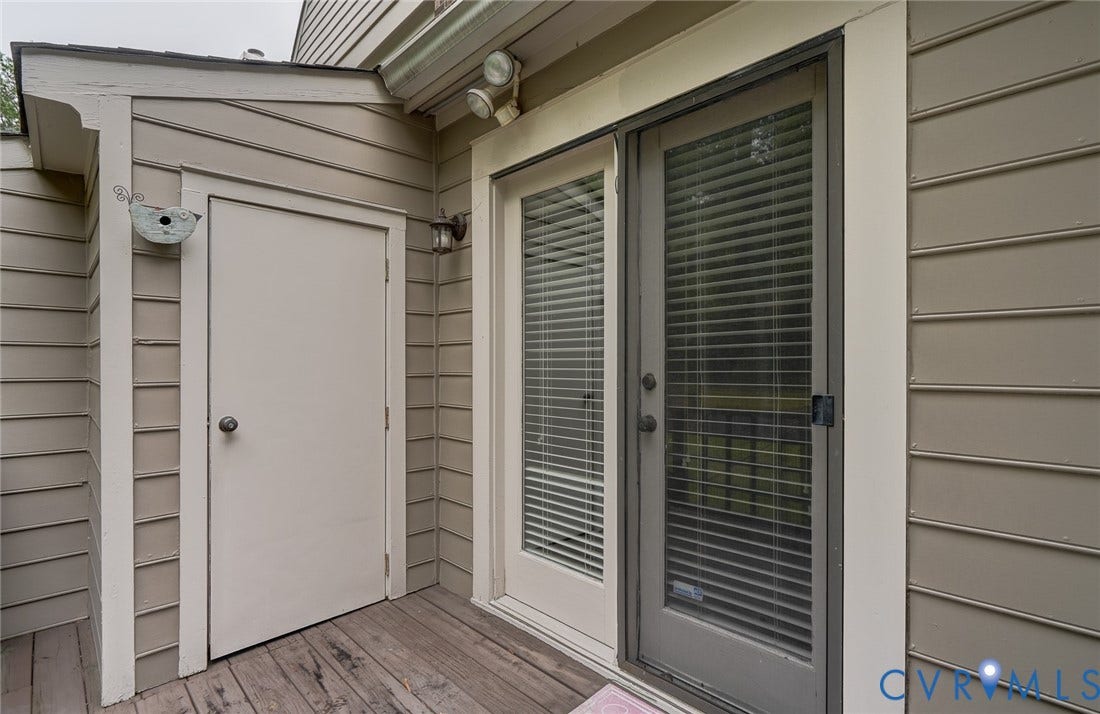 1109 Lakeland Circle, Henrico, VA 23229 Exterior entryway featuring horizontal lap siding, a dedicated storage closet, integrated security lighting, and a glass-panel door with a screened storm door
