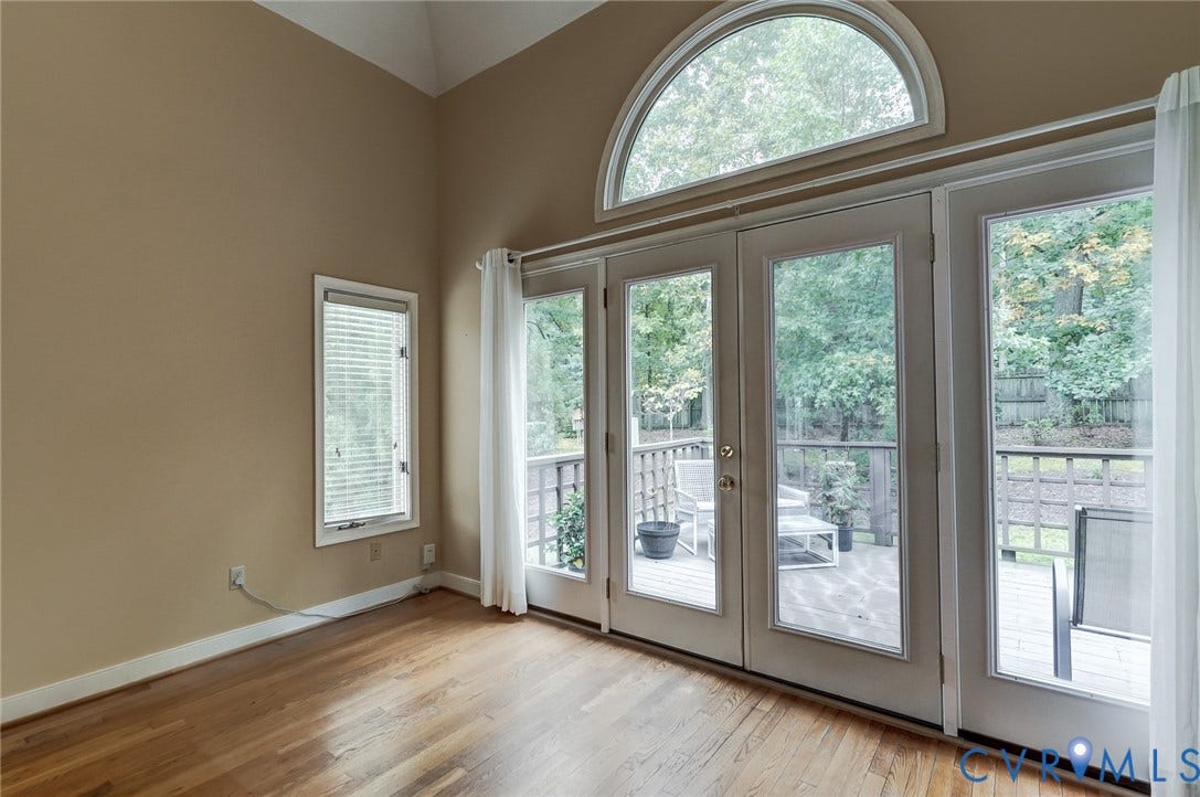 1109 Lakeland Circle, Henrico, VA 23229 Vaulted ceilings, wood-finish flooring, double glass doors with a half-moon window, and a wood deck