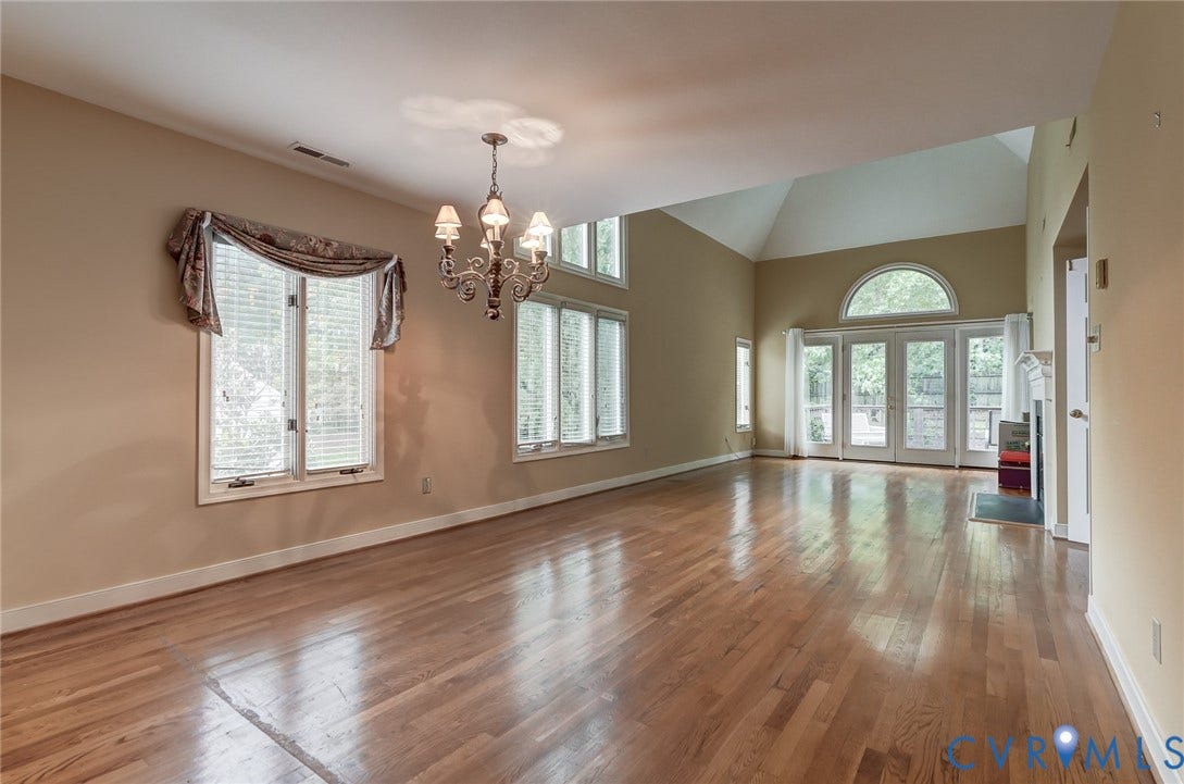 1109 Lakeland Circle, Henrico, VA 23229 Vaulted ceilings, wood-finish flooring, multi-pane windows, a decorative chandelier, and double French doors with a semi-circular transom