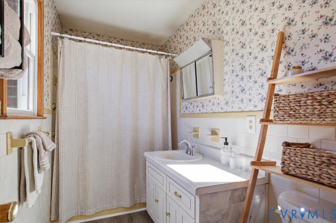 2609 Maury Road, Prince George, VA 23805 Bathroom featuring a white vanity cabinet with an integrated sink, a built-in recessed medicine cabinet, classic subway tile wall surround, and a tub-shower combination