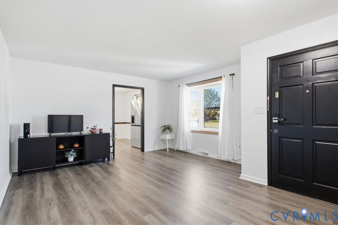 2609 Maury Road, Prince George, VA 23805 Neutral interior featuring wood-finish flooring, a matte black paneled entry door, and a multi-pane window