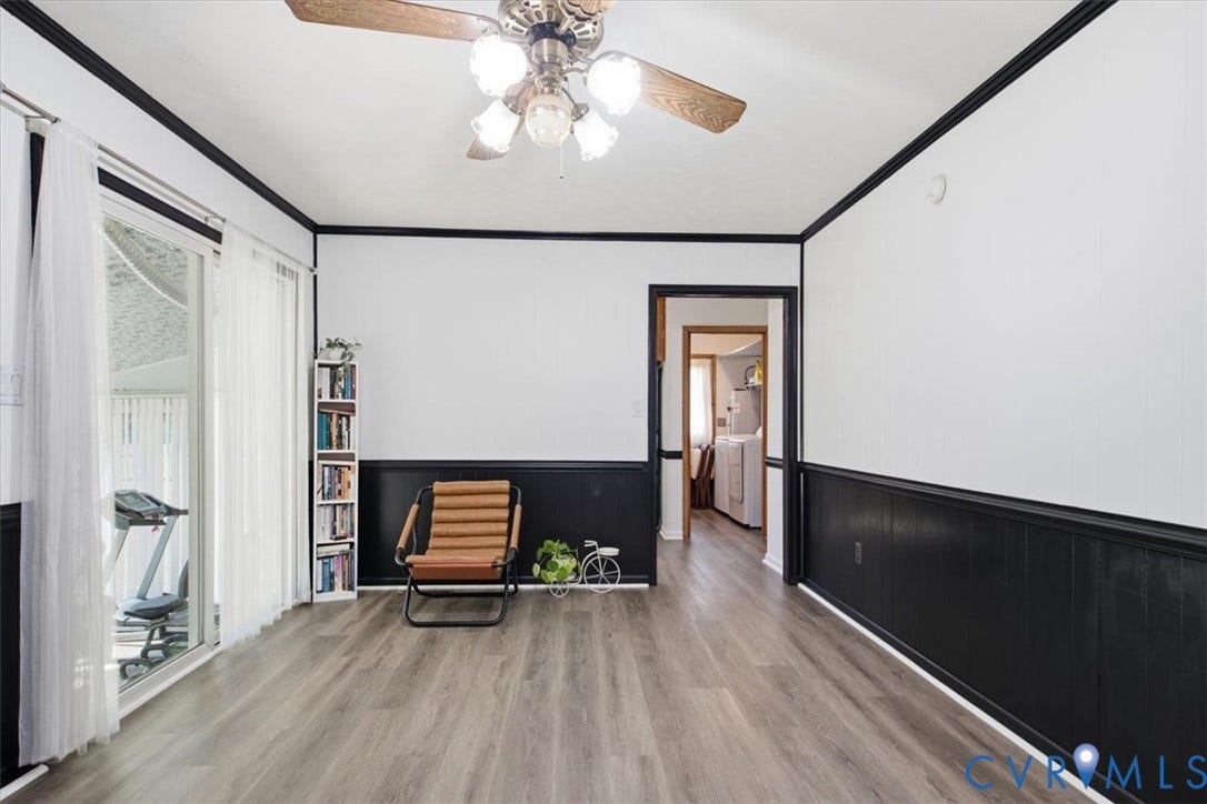 2609 Maury Road, Prince George, VA 23805 Interior space featuring wood-finish flooring, high-contrast wainscoting, crown molding, a multi-light ceiling fan, and a sliding glass door