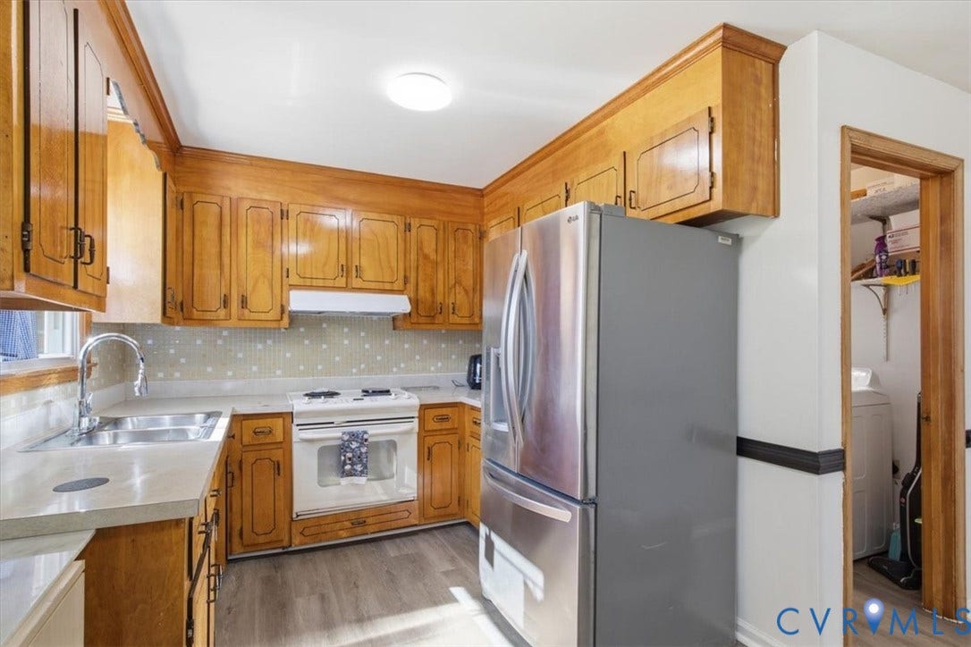 2609 Maury Road, Prince George, VA 23805 Kitchen featuring wood cabinetry, stainless steel refrigerator, white electric range, integrated backsplash, and wood-finish flooring