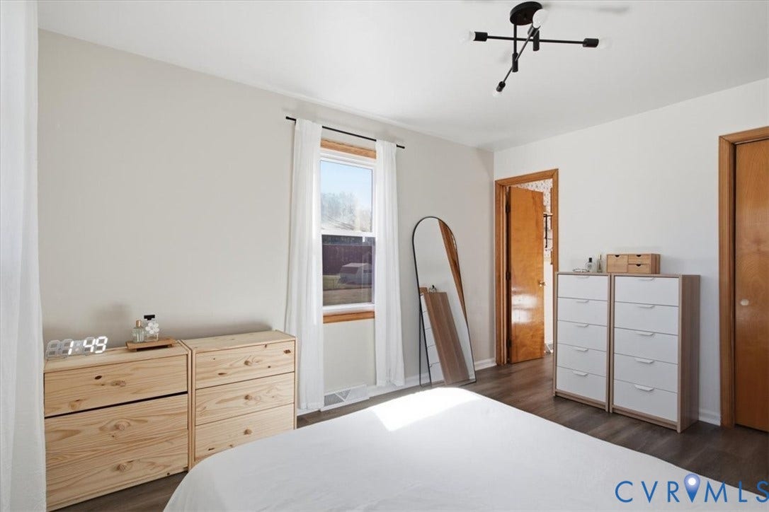 2609 Maury Road, Prince George, VA 23805 Room featuring wood-finish flooring, a multi-arm modern light fixture, and natural wood door frames