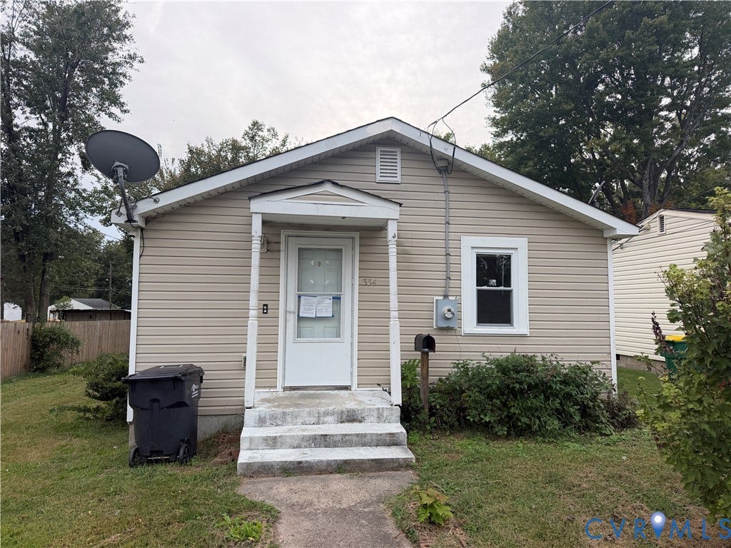 334 S 17th Avenue, Hopewell, VA 23860 Exterior featuring light-toned horizontal siding, a gabled roofline, and a covered front entryway with decorative support columns
