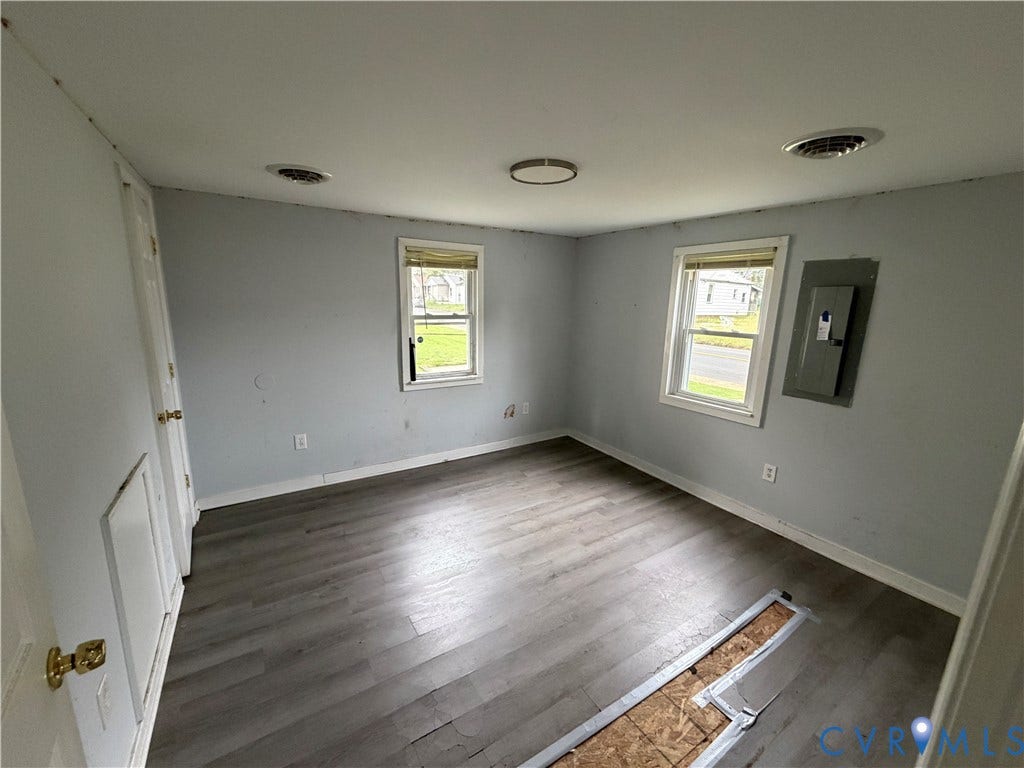 334 S 17th Avenue, Hopewell, VA 23860 Interior space featuring wood-finish flooring, two windows with blinds, and a flush-mount ceiling fixture