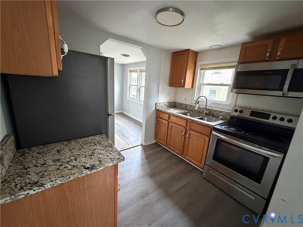 334 S 17th Avenue, Hopewell, VA 23860 Kitchen featuring stone countertops, wood-finish cabinetry, stainless steel appliances, and wood-finish flooring