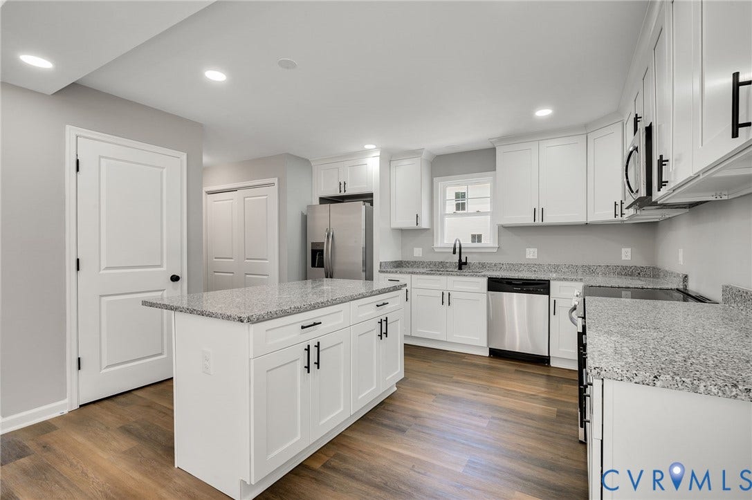 914 Diamond Street, Petersburg, VA 23803 Kitchen featuring white shaker-style cabinetry, stone-finish countertops, stainless steel appliances, a center island, and wood-finish flooring