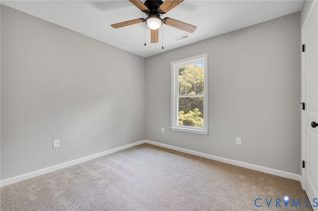 914 Diamond Street, Petersburg, VA 23803 Neutral-toned interior featuring wall-to-wall carpeting, a ceiling fan with integrated lighting, and a single-hung window with exterior greenery