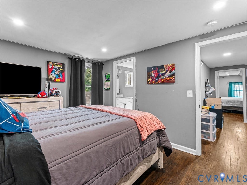 Wood-finish flooring, recessed lighting, and neutral wall tones
