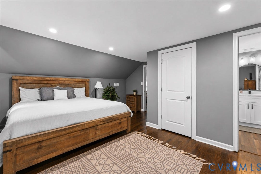 Wood-finish flooring, recessed lighting, and a neutral color palette featuring painted walls and interior panel doors