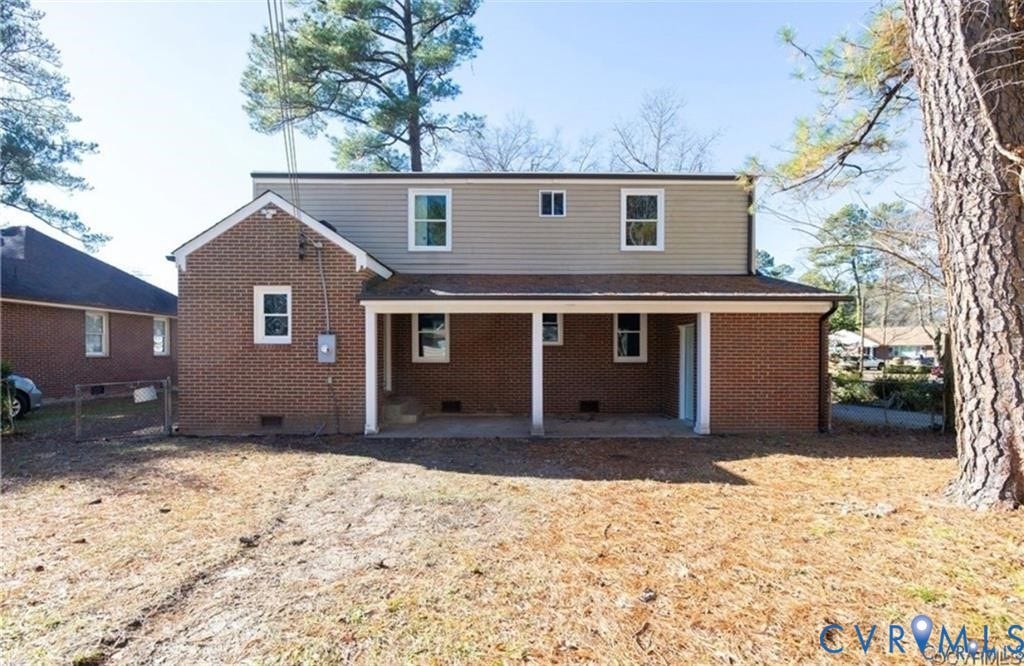 Brick exterior siding, multi-level roofline, covered porch, and horizontal siding