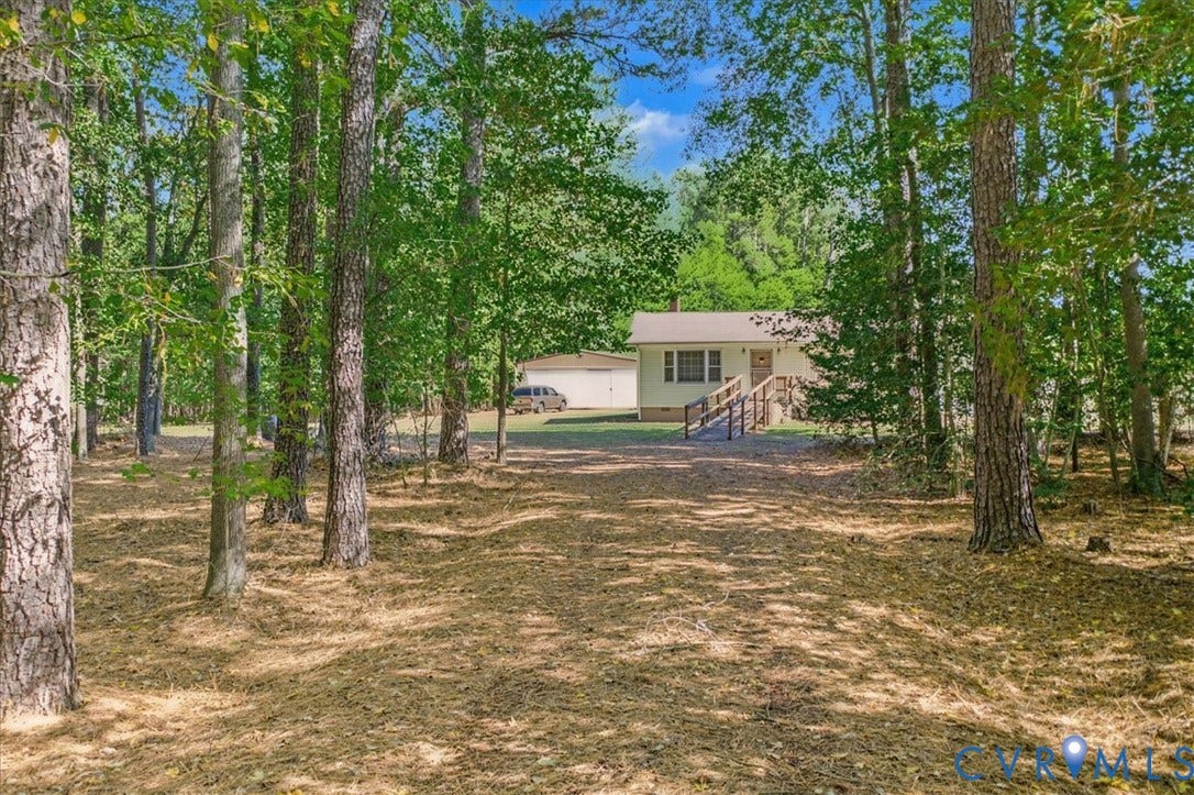 14421 Alden Road, Disputanta, VA 23842 Detached garage with siding, wooded lot with mature trees, and exterior ramp