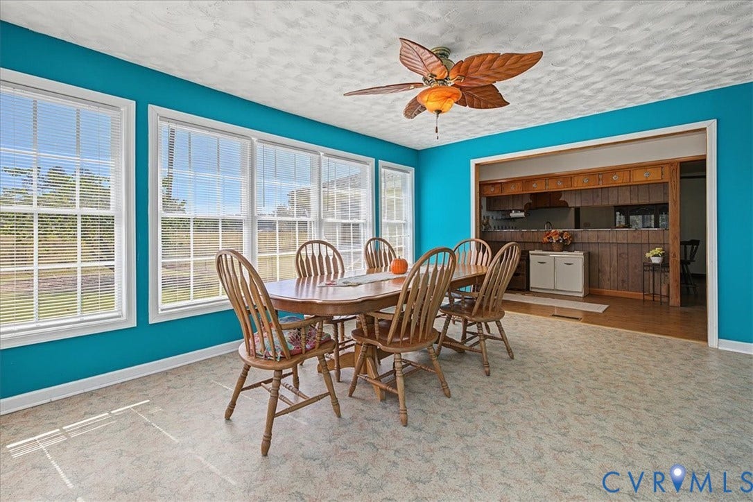 14421 Alden Road, Disputanta, VA 23842 Bright room featuring large multi-pane windows, textured ceiling, leaf-blade ceiling fan, and resilient flooring