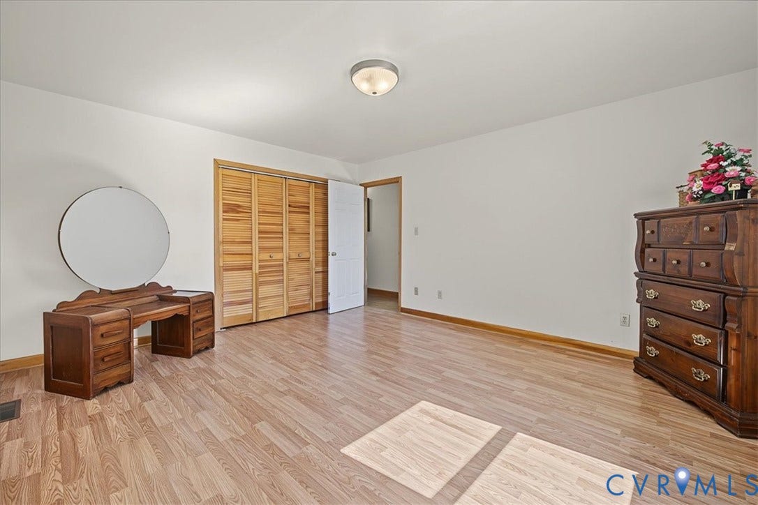 14421 Alden Road, Disputanta, VA 23842 Wood-finish flooring, flush-mount dome lighting, and folding wood-panel closet doors
