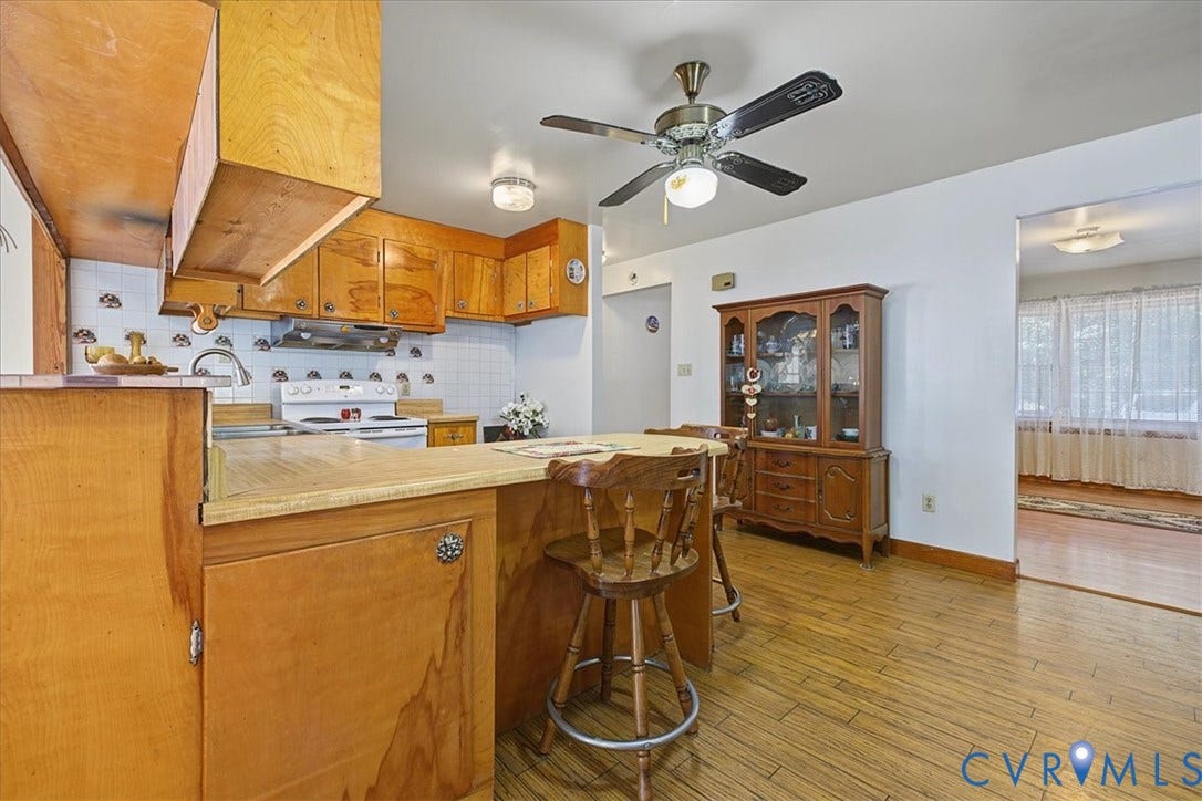 14421 Alden Road, Disputanta, VA 23842 Kitchen featuring natural wood cabinetry, a peninsula with counter seating, wood-finish flooring, and a ceiling fan with integrated lighting